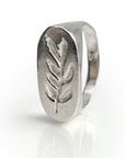 Branch Signet ring in sterling silver featuring hand-carved olive leaf design, showcasing neo-classical style reminiscent of ancient Roman nobility. Unique oval-shaped face with detailed leaf motif on a polished band, reflecting craftsmanship and elegance.