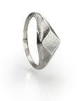 Handcrafted sterling silver diamond-shaped signet ring with organic texture and unique polish, showcasing artisanal wax mold technique for a one-of-a-kind jewelry piece