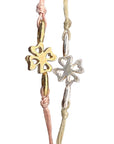 Delicate Lucky Clovers bracelets featuring gold and silver four-leaf clover charms, showcasing intricate heart-shaped cutouts in the clover design for a stylish and fortunate accessory