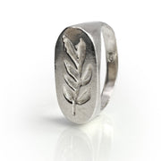 Branch Signet ring in sterling silver featuring hand-carved olive leaf design, showcasing neo-classical style reminiscent of ancient Roman nobility. Unique oval-shaped face with detailed leaf motif on a polished band, reflecting craftsmanship and elegance.