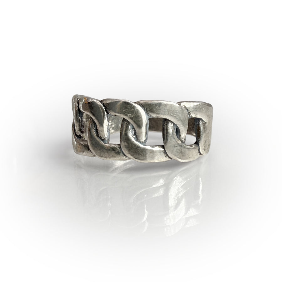 Sterling silver chain link band ring with intricately detailed, hand-shaped design showcasing a timeless aesthetic. Meticulously crafted wax-cast jewelry piece reflecting artisanal quality and unique style.