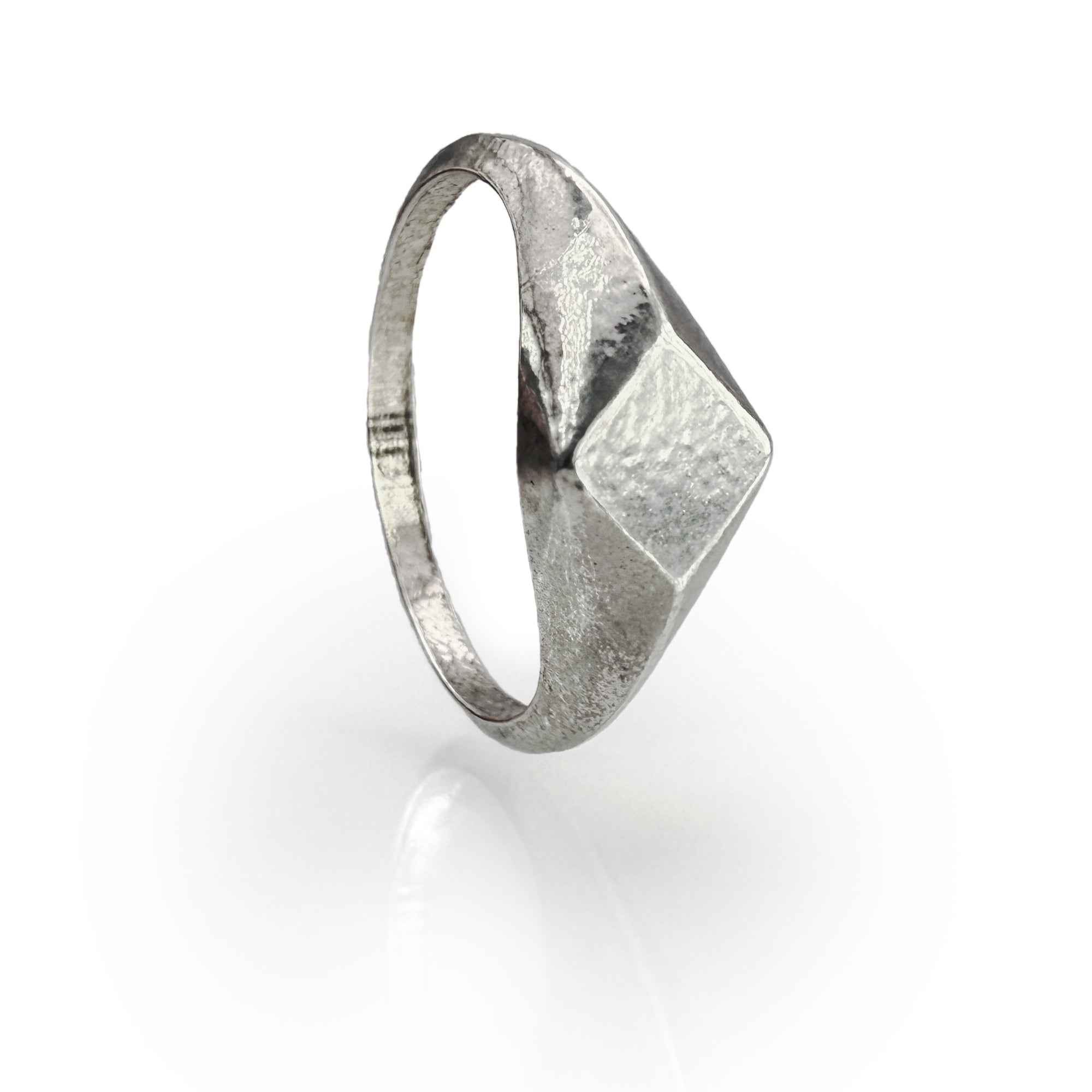 Handcrafted sterling silver diamond-shaped signet ring with organic texture and unique polish, showcasing artisanal wax mold technique for a one-of-a-kind jewelry piece