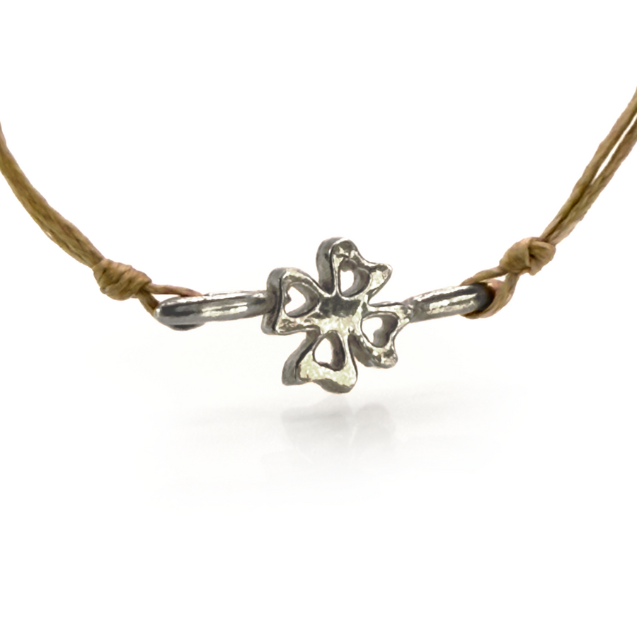 Delicate four-leaf clover bracelet with silver charm, symbolizing luck and style. Adjustable design showcases intricate clover detail for a charming, versatile accessory suitable for everyday wear or special occasions.