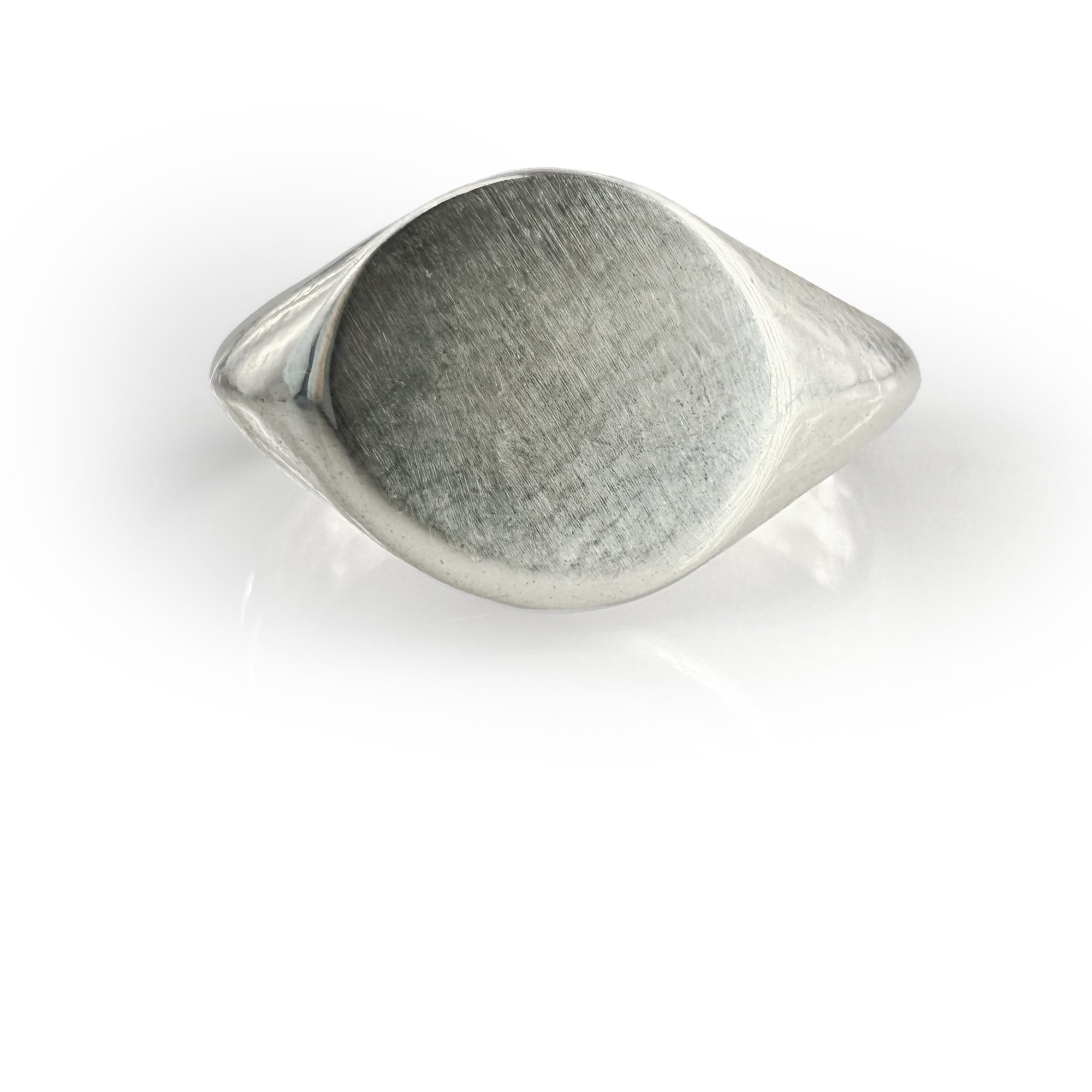 Handcrafted oval mirror signet ring in sterling silver with unique organic texture, featuring a smooth bevel and polished finish, perfect for custom engraving or as a statement piece