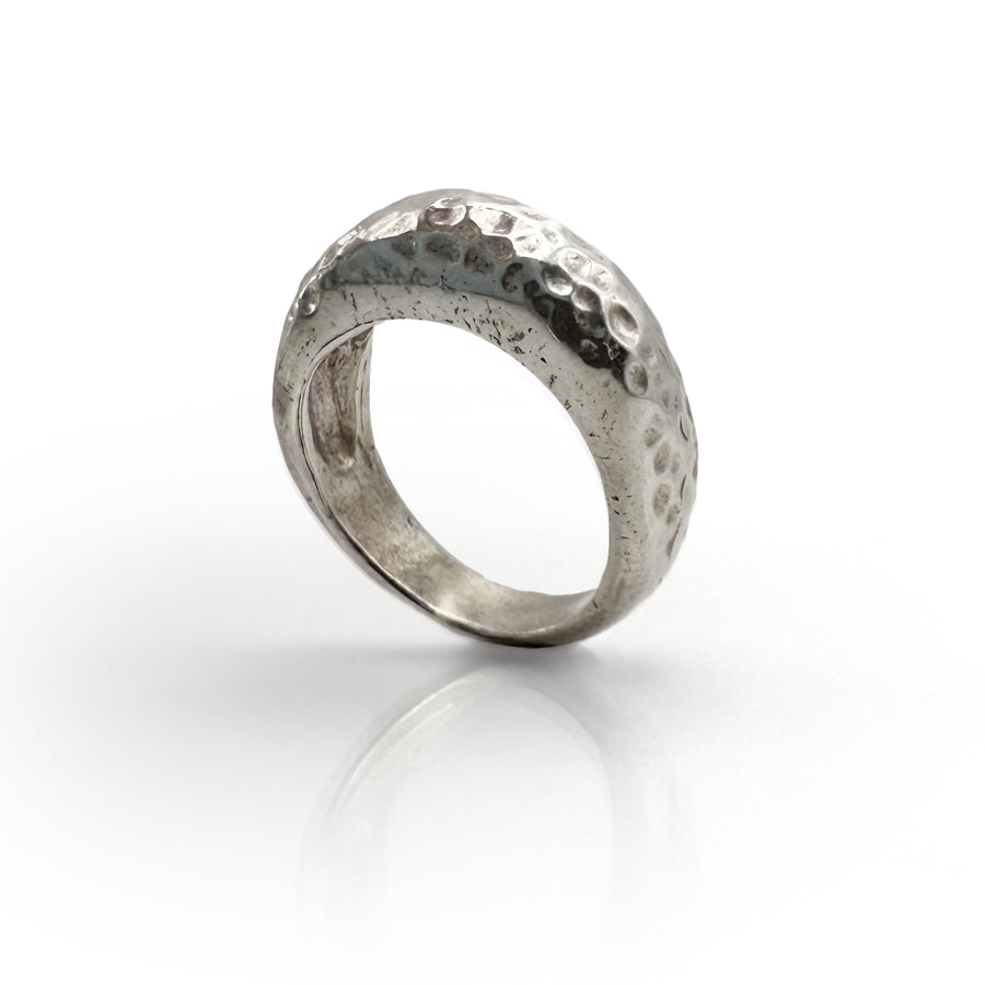 Handcrafted sterling silver Pumice Statement ring with unique textured surface, inspired by volcanic lava glass. Wide band with hammered, porous-looking design reflecting natural pumice formation. Elegant, organic-inspired jewelry piece.