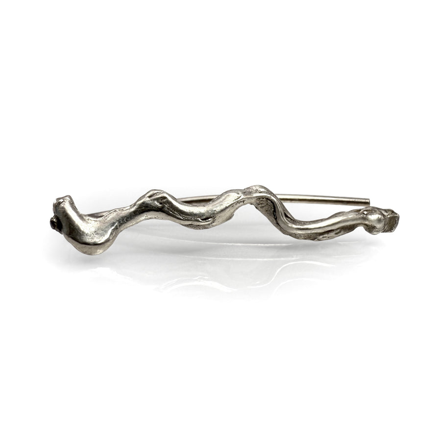 Elegant silver ear climber earring with wavy, flowing design inspired by water ripples, showcasing a unique handcrafted shape for a stylish statement piece