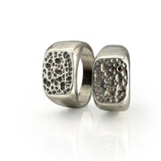 Square Pumice Signet rings with intricate porous texture resembling volcanic lava glass, cast in sterling silver with unique natural patterns, showcasing the beauty of nature-inspired jewelry design