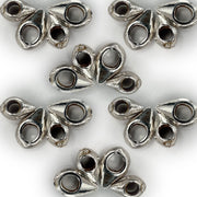 Metallic silver drop-shaped ornaments with hollow centers arranged in a symmetrical pattern on a white background, showcasing their versatile design for jewelry making.