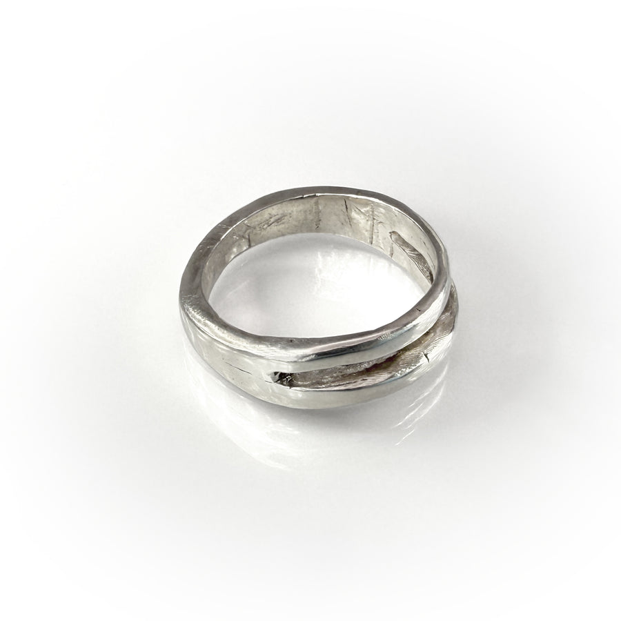 Elegant Twin Band ring in sterling silver, featuring two parallel bands seamlessly joined, reflecting light with its polished surface, showcasing timeless design and craftsmanship