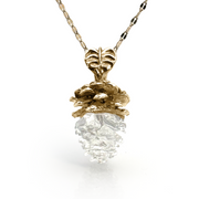 Elegant Mama Pine pendant necklace featuring a real pinecone with gold-plated top half and clear resin bottom, suspended on a delicate chain, showcasing nature-inspired artistry and craftsmanship