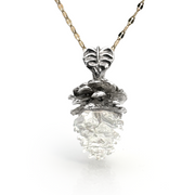 Mama Pine pendant necklace featuring a real pinecone with metallic top half and clear resin bottom half, suspended on a delicate chain, showcasing nature-inspired elegance and artistry